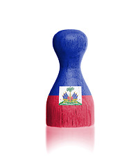 Image showing Wooden pawn with a painting of a flag