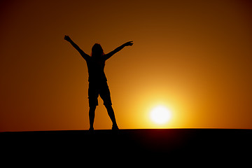 Image showing Person enjoys to the sun at sunset