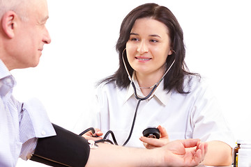 Image showing doctor measuring  blood pressure  of senior man