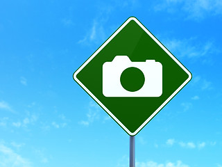 Image showing Vacation concept: Photo Camera on road sign background