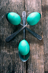 Image showing Teal Easter Eggs with spoons