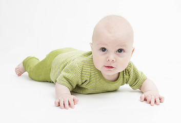 Image showing curious toddler in green clothing