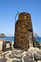 Image showing tower   hill yellow  beach    black rocks in the   lanzarote 