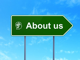 Image showing Marketing concept: About Us and Head With Gears on road sign background