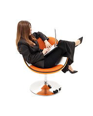 Image showing elegant businesswoman with laptop in orange chair