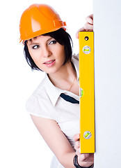 Image showing Pretty girl in helmet with level