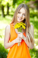 Image showing Spring girl with bunch of dandelions