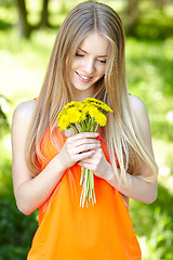 Image showing Spring girl with bunch of dandelions