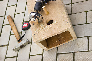 Image showing Drilling holes in the birdhouse