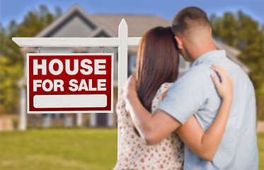 Image showing For Sale Real Estate Sign, Military Couple Looking at House