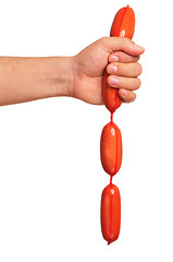 Image showing Hand with sausage