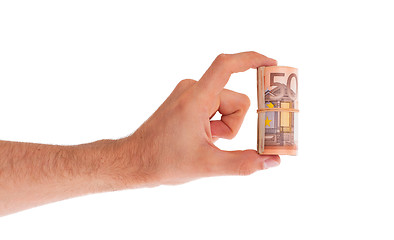 Image showing Roll of 50 euro bills in hand