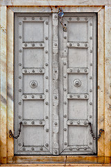 Image showing Agra, India. The old gray wooden door