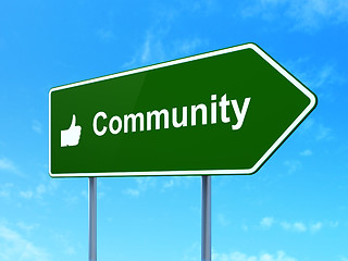 Image showing Social network concept: Community and Thumb Up on road sign background