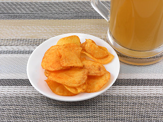 Image showing Mug of Fresh Beer and plate with Pile potato chips