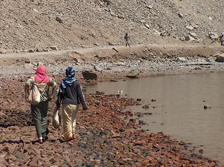 Image showing Veiled arab women talking and walking on a beach