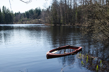 Image showing Water filled rowboat