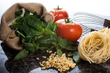 Image showing Italian cooking ingredients on a black granite tabletop.