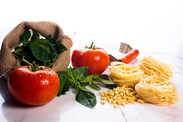 Image showing Italian cooking ingredients on a white marble tabletop.