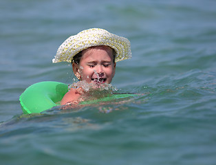 Image showing little girl in sea on inflatable disc