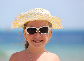 Image showing happy little girl in sunglasses on beach