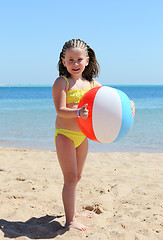 Image showing happy little girl with ball on beach