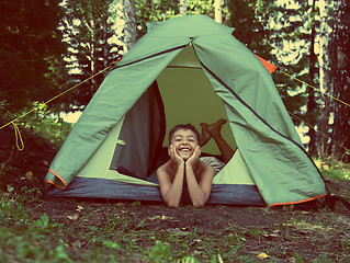 Image showing happy boy in camping tent - vintage retro style