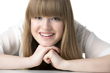 Image showing Laughing blond girl on table