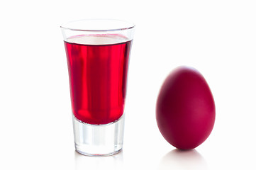 Image showing Red easter egg with a glass of drink