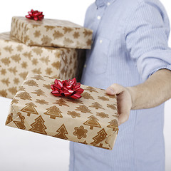 Image showing Young man holding a present