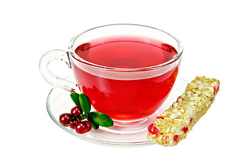 Image showing Tea with cowberry in glass cup and granola