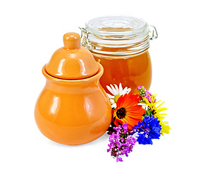 Image showing Honey in a jug and jar with flowers