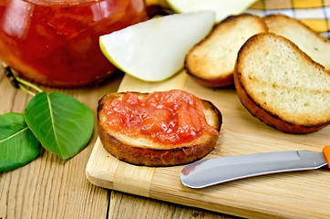 Image showing Bread with pear jam on a board