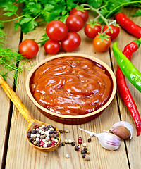 Image showing Ketchup in pottery with spices on board