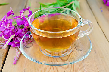 Image showing Herbal tea in glass cup of fireweed on board