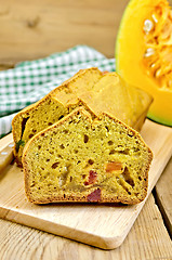 Image showing Fruitcake pumpkin with candied fruit and knife on board