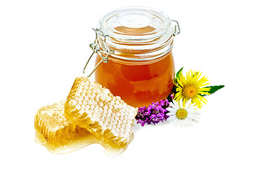 Image showing Honeycomb with a jar and flowers