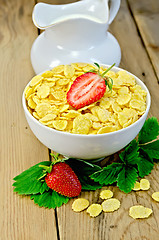 Image showing Cornflakes with strawberries and milk on board