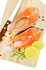 Image showing Trout with rosemary and knife on plank