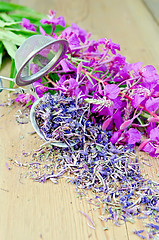 Image showing Herbal tea with strainer of fireweed on board