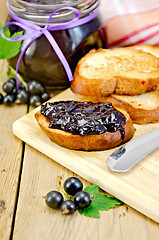 Image showing Bread with black currant jam on the board