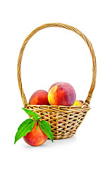 Image showing Peaches with leaves and basket
