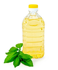 Image showing Vegetable oil in a bottle with basil