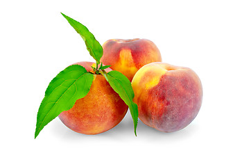 Image showing Peaches whole with green leaves