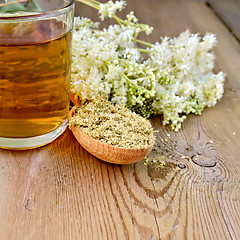 Image showing Herbal tea of meadowsweet dried in spoon and mug