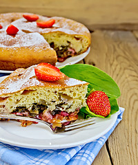 Image showing Pie with strawberry and sorrel on boards