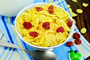 Image showing Cornflakes with dried cherries and milk on board