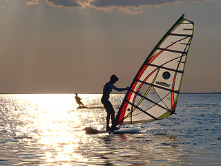 Image showing A women is learning windsurfing at the sunset