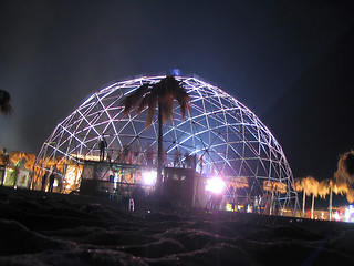 Image showing people dancer with a metal dome on the beach at night