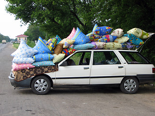 Image showing Cars loaded coloured bag on the sidelines. funny picture